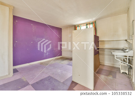 an empty room with purple paint on the walls and flooring area in front of the door to the bathroom an empty room with purple paint on the walls and flooring area in front of the door to the bathroom 105338532