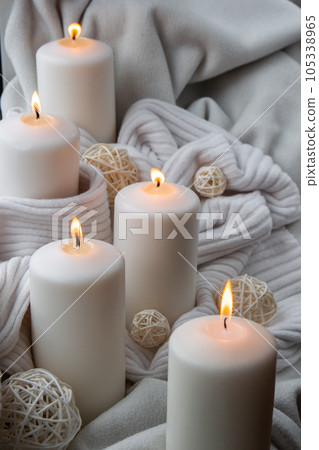 Home fragnance concept autumn holidays at cozy home on the windowsill Hygge aesthetic atmosphere on knitted white sweater. Still life of micro moment candid slow living. Mental health wellbeing Home fragnance concept autumn holidays at cozy home on the windowsill Hygge aesthetic atmosphere on knitted white sweater. Still life of micro moment candid slow living. Mental health wellbeing 105338965