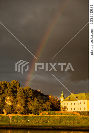 Heavy rain and rainbow above the Vistula river in Krakow Poland. Stunning views of the city rainy season and rainbow 105338981