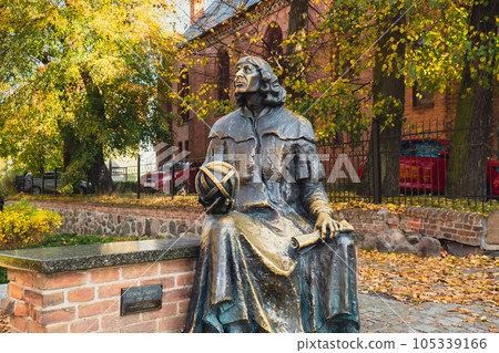 Olsztyn Poland - October 2022 Planet in hand of Nicolaus Copernicus statue near his famous castle. Nicolaus Copernicus statue on the Old Town in Olsztyn. Famous tourist attraction travel Olsztyn Poland - October 2022 Planet in hand of Nicolaus Copernicus statue near his famous castle. Nicolaus Copernicus statue on the Old Town in Olsztyn. Famous tourist attraction travel 105339166