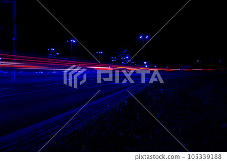 Lights of cars at night. Street line lights. Night highway city. Long exposure photograph night road. Colored bands of red light trails on the road. Background wallpaper defocused  105339188