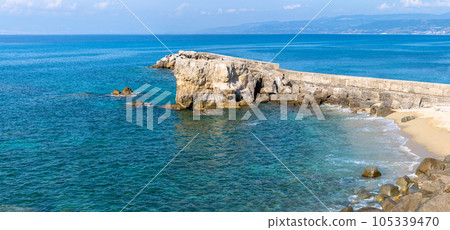 View of coastline in southern Italy. Scenic view from on top cliff looking out to sea. Calabria coastline with eroded cliff View of coastline in southern Italy. Scenic view from on top cliff looking out to sea. Calabria coastline with eroded cliff 105339470