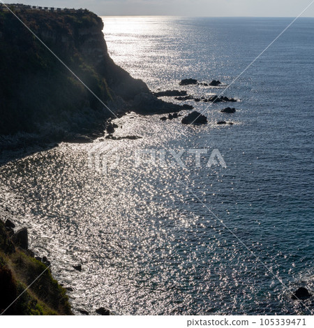 View of coastline in southern Italy. Scenic view from on top cliff looking out to sea on sunny summer day. Calabria coastline with eroded cliff View of coastline in southern Italy. Scenic view from on top cliff looking out to sea on sunny summer day. Calabria coastline with eroded cliff 105339471