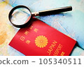 Passport and magnifying glass on a world map 105340511