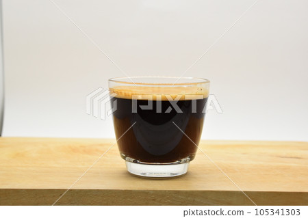 glass of hot black coffee put on wood background glass of hot black coffee put on wood background 105341303