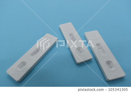 covid test kit on blue background covid test kit on blue background 105341305
