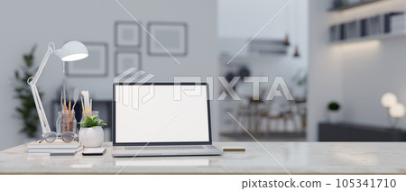 A laptop mockup on a table in a modern contemporary living room. close-up workspace. 105341710