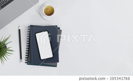 Top view of workspace with mock up smartphone on notebooks and copy space on white table. 105341768