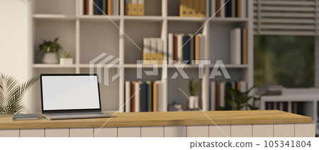A portable laptop mockup on a wooden countertop in a modern bookshop or library. A portable laptop mockup on a wooden countertop in a modern bookshop or library. 105341804