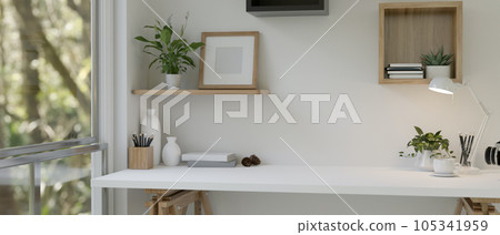 A minimal white tabletop with copy space against the white wall near the window. A minimal white tabletop with copy space against the white wall near the window. 105341959
