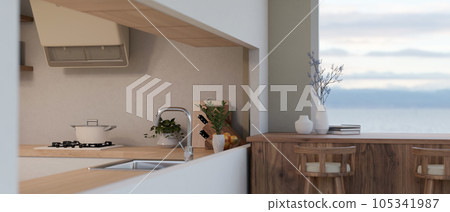 A modern minimalist kitchen with wooden counter bar table, stools, cooking space A modern minimalist kitchen with wooden counter bar table, stools, cooking space 105341987