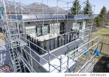 House renovation House in the process of painting the outer wall and replacing the roof (aerial view) 105342283