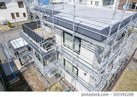 House renovation House in the process of painting the outer wall and replacing the roof (aerial view) 105342286