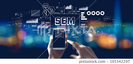 SEM with person using a smartphone at night 105342297