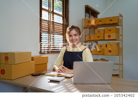 Small business startup SME owner asian woman checking orders sell products that work with boxes. work independently at home, online SME business 105342402
