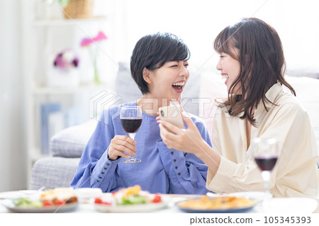 Drinking at home: A woman drinking wine at home 105345393