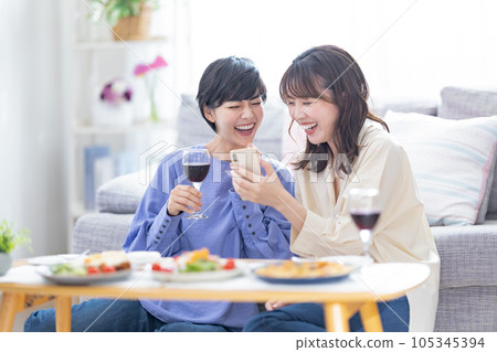 Drinking at home: A woman drinking wine at home 105345394