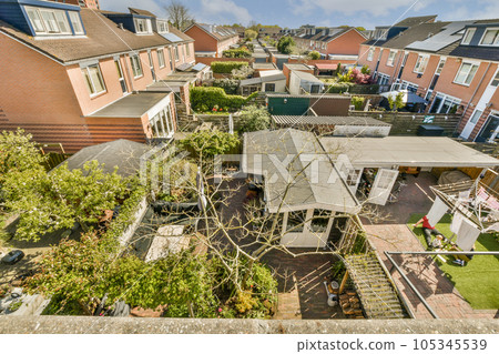an aerial view from the roof of a house with trees and bushes in the fore - image taken from above 105345539