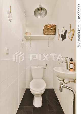a bathroom with black and white tiles on the floor, along with a toilet in the sink is next to the wall 105345653