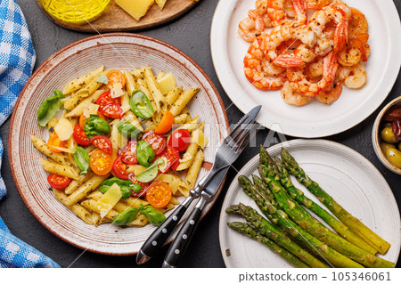 Italian pasta adorned with fresh tomatoes and aromatic basil Italian pasta adorned with fresh tomatoes and aromatic basil 105346061