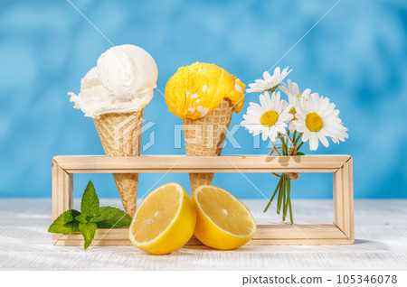 Refreshing ice cream in waffle cones with lemon flavour Refreshing ice cream in waffle cones with lemon flavour 105346078