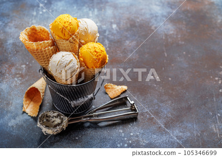 Assorted ice cream flavours in delightful waffle cones 105346699
