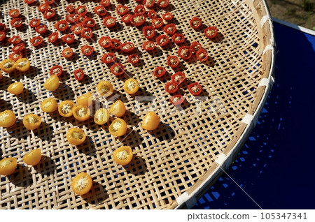 Sundried tomatoes drying on a bamboo colander 105347341