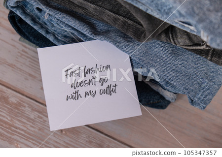 FAST FASHION DOESNT GO WITH MY OUTFIT text on paper note on Jeans clothes assortment Second hand sustainable shopping. Capsule minimal wardrobe. Sustainable fashion overconsumption, conscious buying FAST FASHION DOESNT GO WITH MY OUTFIT text on paper note on Jeans clothes assortment Second hand sustainable shopping. Capsule minimal wardrobe. Sustainable fashion overconsumption, conscious buying 105347357