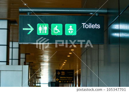 Toilet sign on the ceiling of entrance to bathroom in Airport Toilet sign concept. Icons set. Male and female restroom Toilet sign on the ceiling of entrance to bathroom in Airport Toilet sign concept. Icons set. Male and female restroom 105347701
