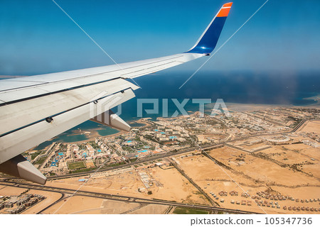 Aerial View of the Red Sea Coast in Hurghada, Egypt with many hotels bay out of airplane landing Aerial View of the Red Sea Coast in Hurghada, Egypt with many hotels bay out of airplane landing 105347736