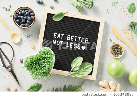 Eat better not less letter board quote flat lay Eat better not less letter board quote flat lay 105348083