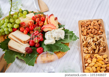 A covered buffet table for a master class. Cheeses, fruits and nuts. Master class and cheese tasting 105348607