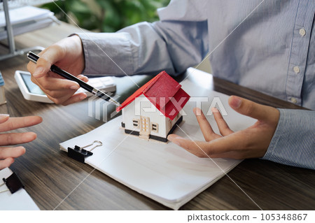 Real Estate Agent and client talking about Property insurance and security concept about house to client before sign contract. Real Estate Agent and client talking about Property insurance and security concept about house to client before sign contract. 105348867