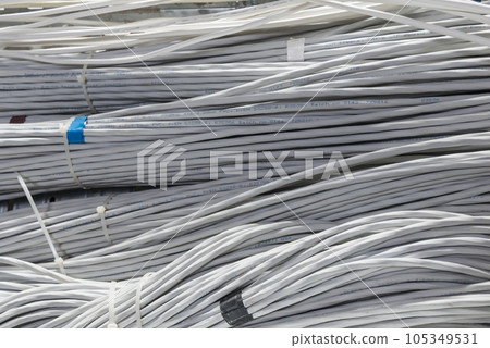 detail of large number of ethernet cables tied together connecting racks inside server room 105349531