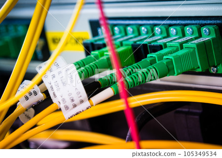 close-up of fiber optics cables connected to server hub close-up of fiber optics cables connected to server hub 105349534