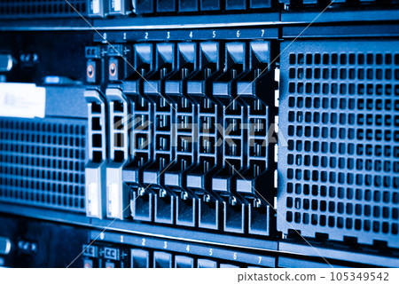 Row of hard drives serving as data storage inside server room 105349542