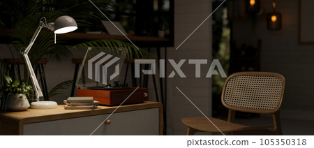 A vintage record player on a minimal drawer in a cozy and minimal living room at night. A vintage record player on a minimal drawer in a cozy and minimal living room at night. 105350318