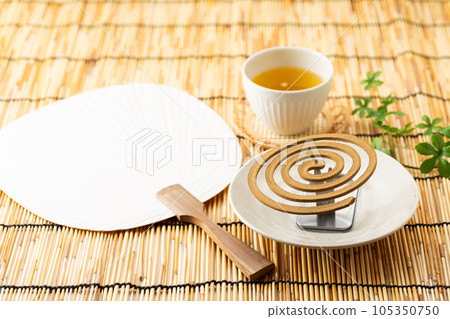 Mosquito coil, paper fan and cold tea (green tea) 105350750