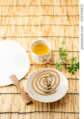 Mosquito coil, paper fan and cold tea (green tea) 105350835