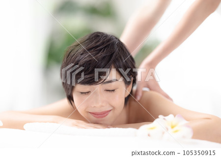 A young woman receiving a massage 105350915
