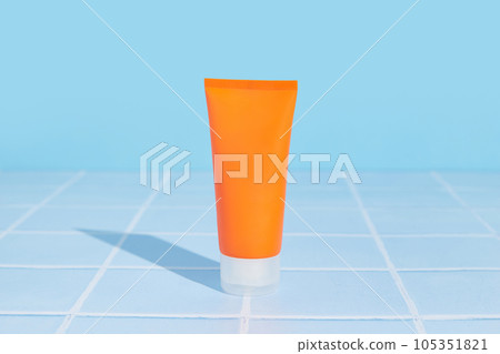 Sunscreen lotion on blue background. Body care beauty treatment 105351821