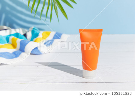 Sunscreen lotion on blue background. Care products summer beach accessories 105351823