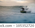 surfer riding waves on the island of fuerteventura 105352720