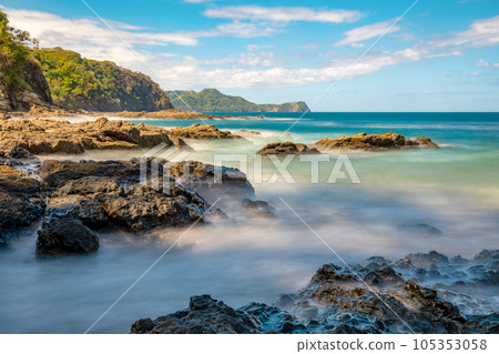 Long exposure, pacific ocean waves on rock in Playa Ocotal, El Coco Costa Rica 105353058