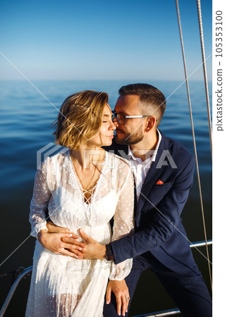 Beautiful wedding couple on yacht at wedding day outdoors in the sea. Together. Wedding day. Beautiful wedding couple on yacht at wedding day outdoors in the sea. Together. Wedding day. 105353100