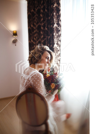 Beautiful bride with wedding flowers bouquet in white luxury dress is getting ready for wedding. Beautiful bride with wedding flowers bouquet in white luxury dress is getting ready for wedding. 105353428