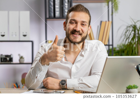 Happy business man looking approvingly at camera showing thumbs up, like positive sign, good news 105353627