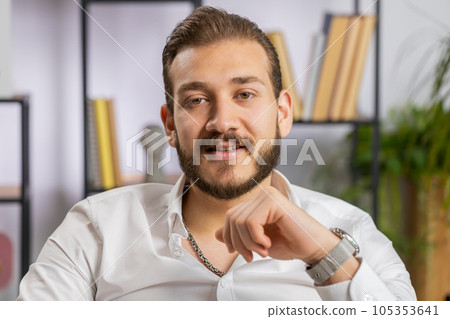 Portrait of happy smiling middle eastern business man at home office look away turn head at camera Portrait of happy smiling middle eastern business man at home office look away turn head at camera 105353641