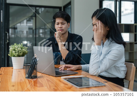 Two Asian business feeling migraine head strain. Overworked businesswoman financier while working on laptop and tablet at office 105357101