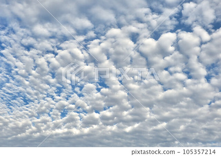 White fluffy clouds on a blue sky background 105357214